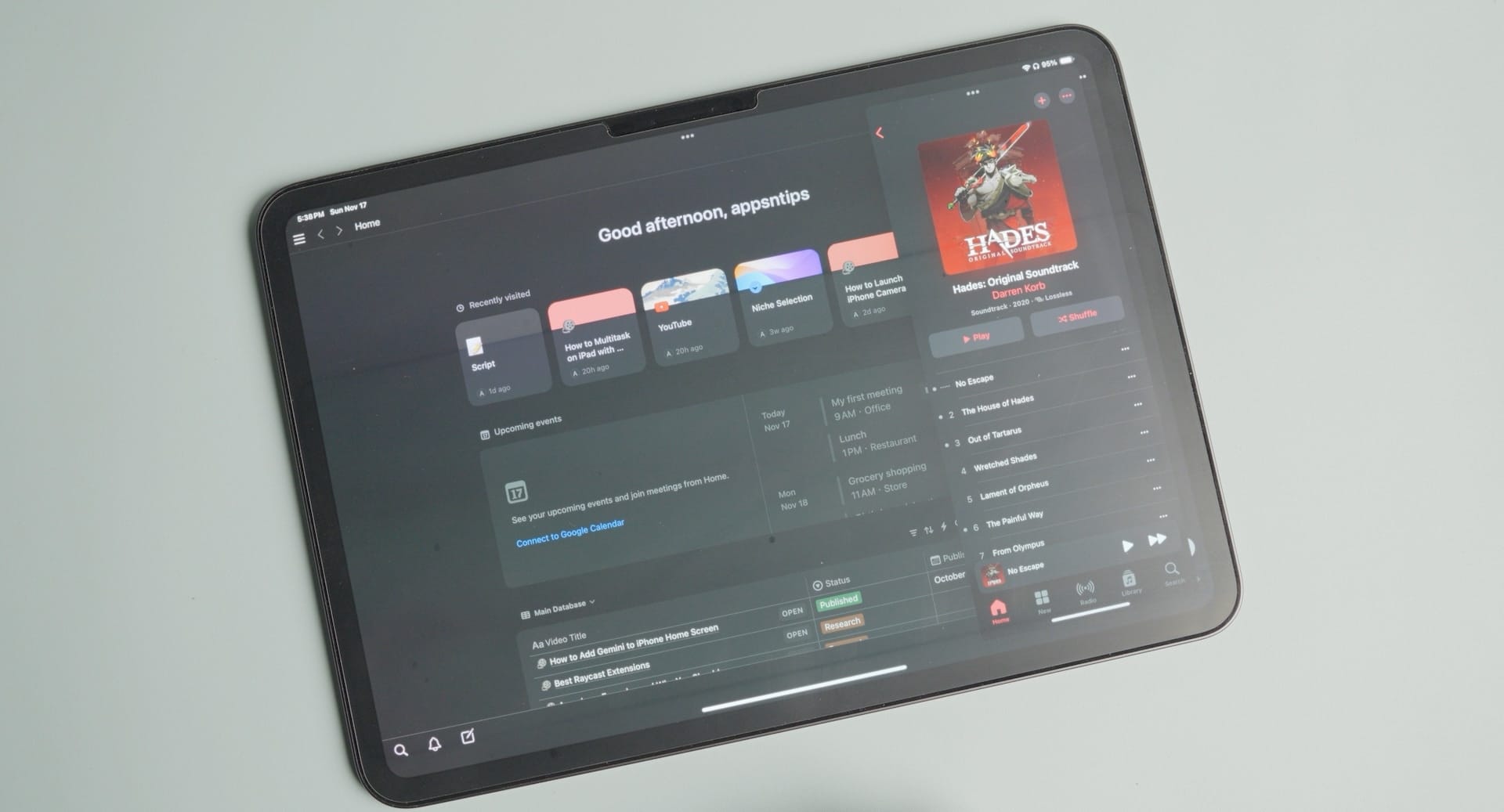 Notion app open on iPad with Music open in Slide Over mode