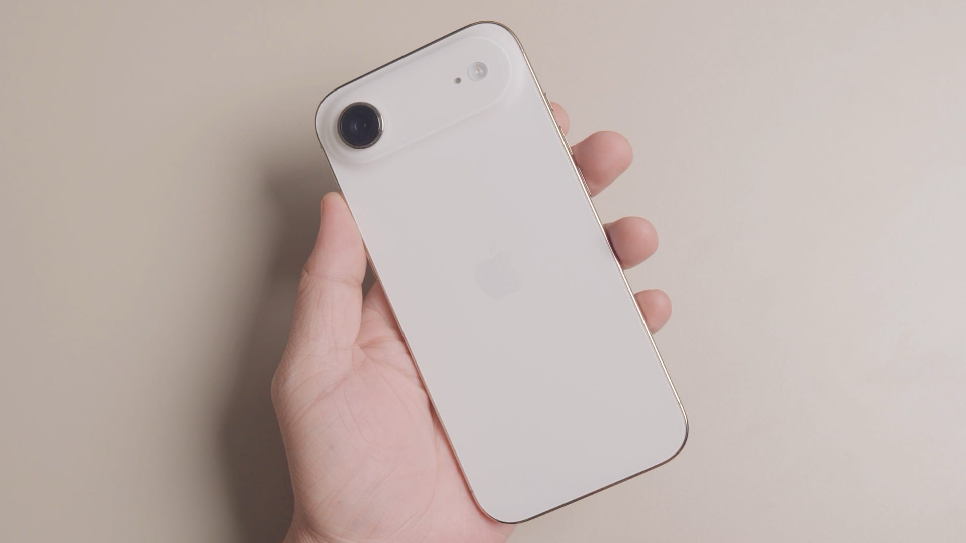male hand holding iPhone Air
