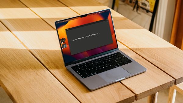 MacBook Pro showing Stage manger feature on top of a wooden table