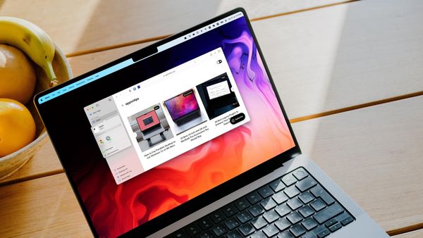 MacBook Pro on wooden table, showing Safari Tab Group sharing feature