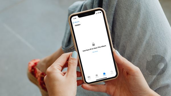 A girl hand holding an iPhone showing the locked Hidden Album
