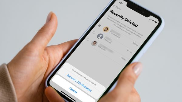 iPhone in hand showing how to recover deleted messages