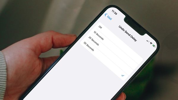 iPhone in hand showing undo send delay feature