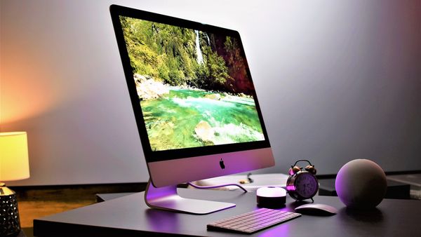 iMac on a table along side keyboard and other acecssories