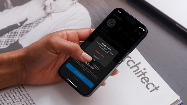 Hand holding iPhone removing Threads badge from Instagram