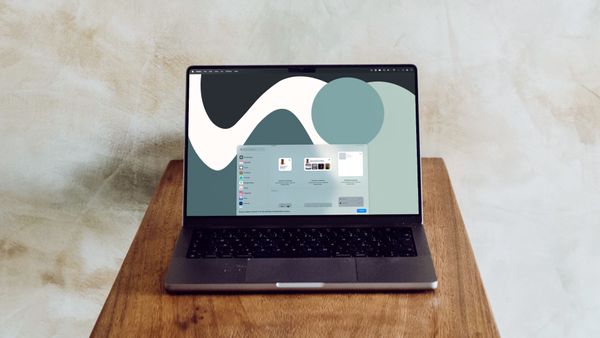 MacBook on wooden platform showing widgets