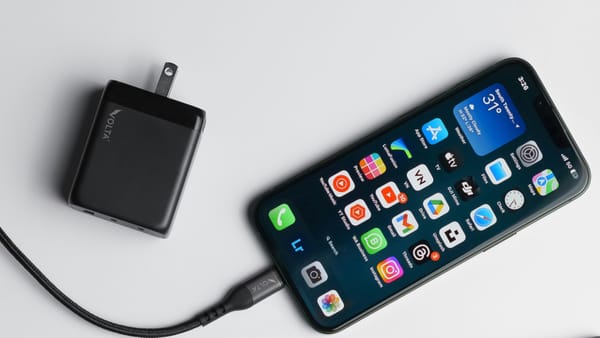 iPhone plugged in showing a power adapter
