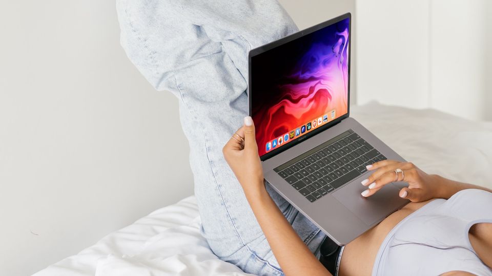 MacBook Pro used by a girl in lying position