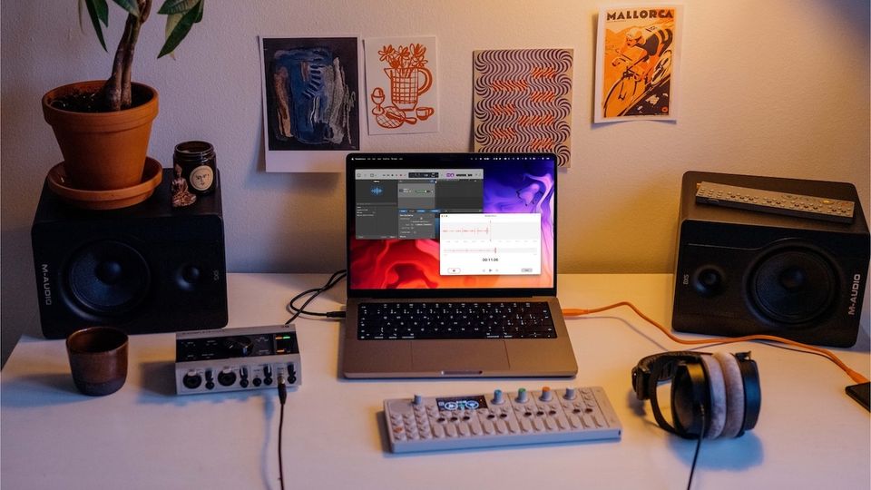 14-inch MacBook Pro in an audio recording setup to record audio on Mac