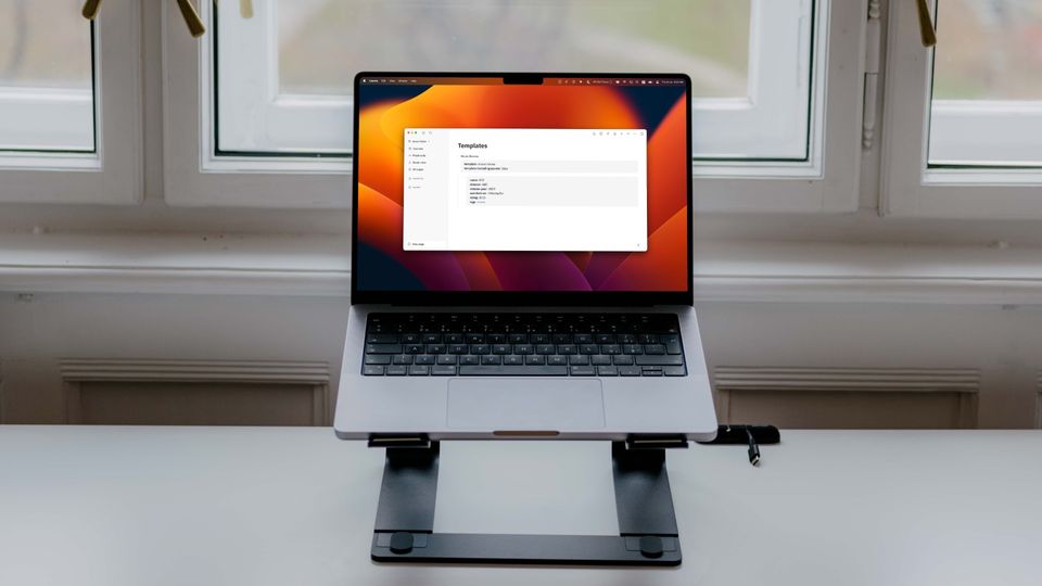 Logseq open in 14-inch MacBook Pro sitting on stand with window as background