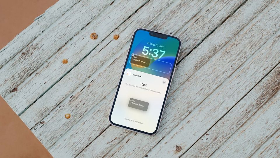 iPhone 13 Pro on table showing upcoming reminders on Lock Screen