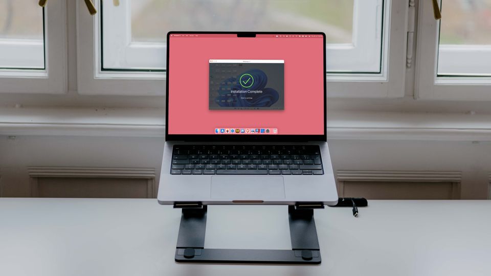 MacBook Pro on stand showing Windows 11 running on Mac using Parallels Desktop app