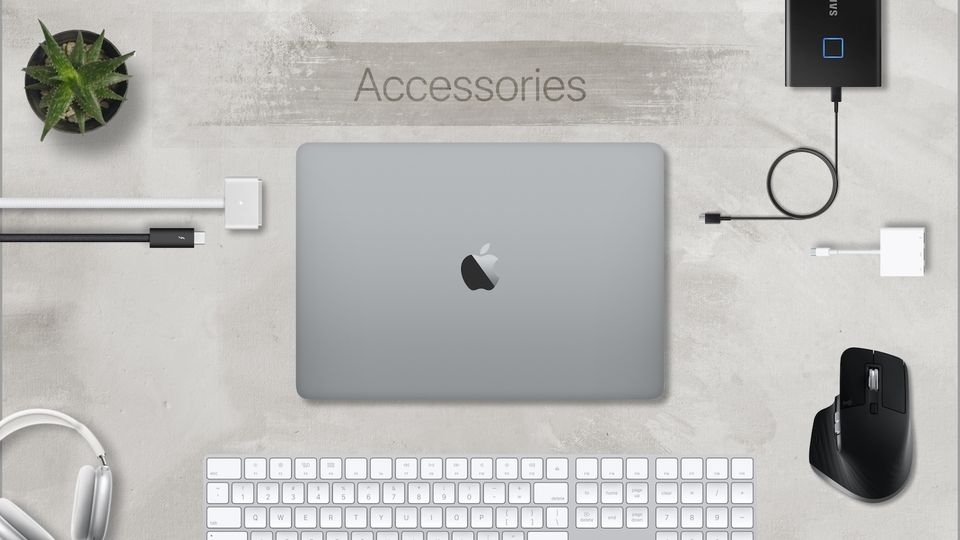 Mac surrounded by accessories like magic keyboard, mouse, SSD, and more